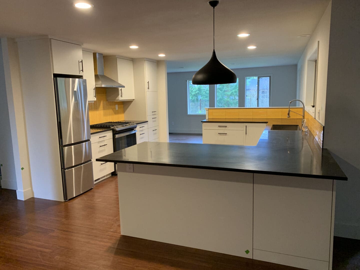 Modern kitchen with island and pendant light.