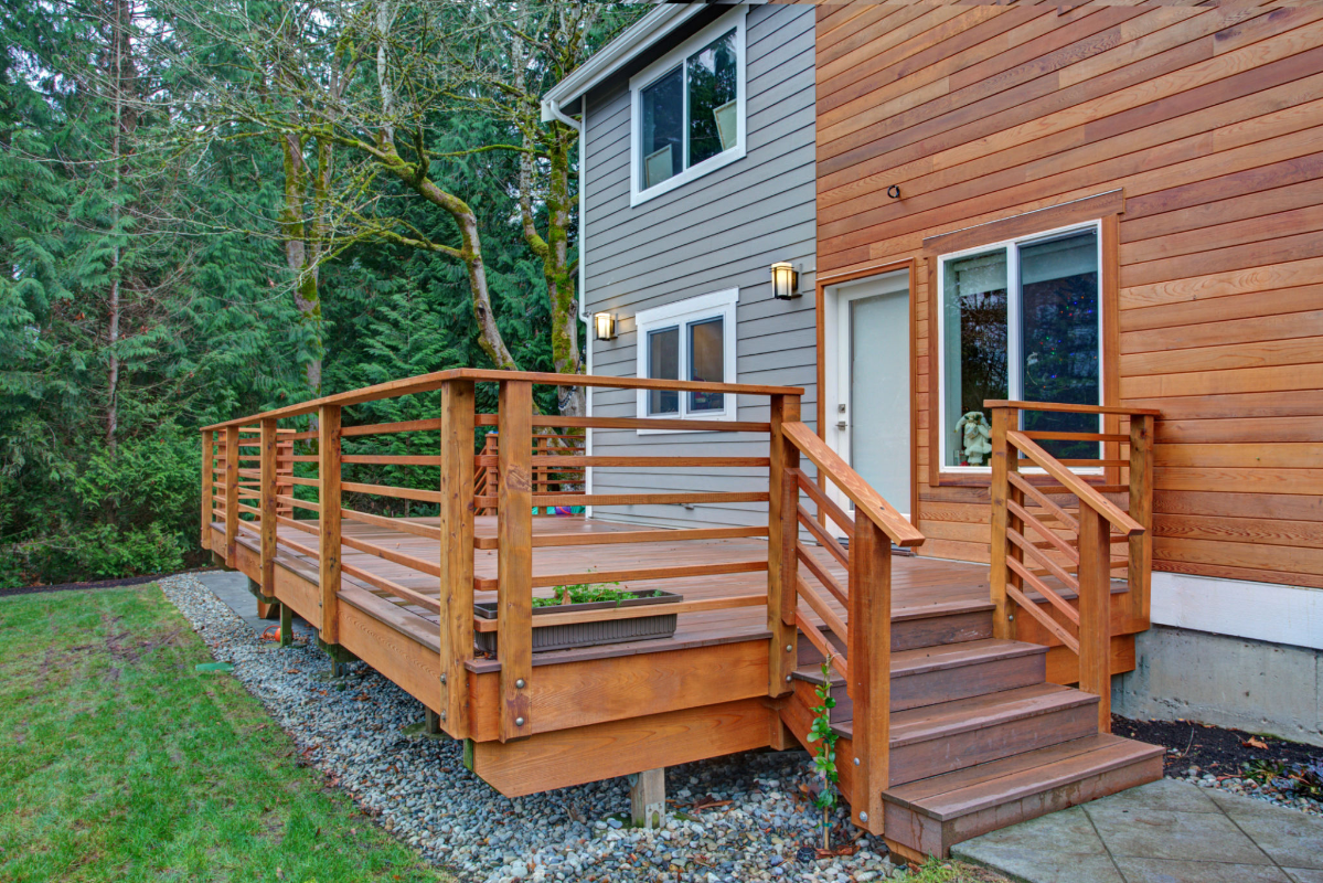 Wooden deck attached to modern house exterior.