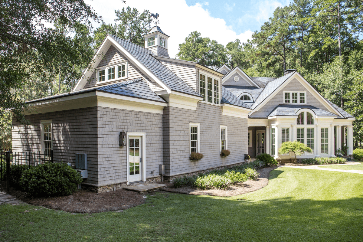 Suburban house with gray siding and garden.